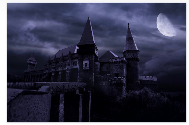 For visually challenged reader, the image shows a castle at night, it’s turrets and towers reflecting moonlight. A cloudy sky can be seen in the background.